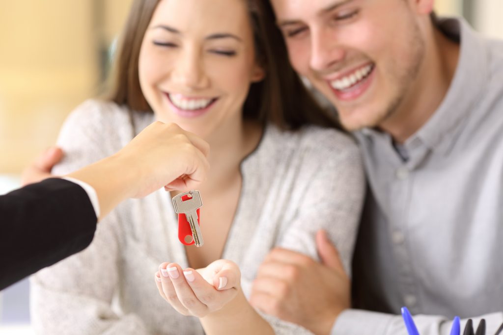 Home owner receiving their house key Homeowners receiving their new house keys