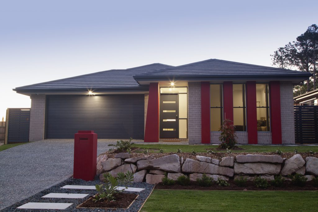 Stylish suburban house front pink and blue contrasting wall paints