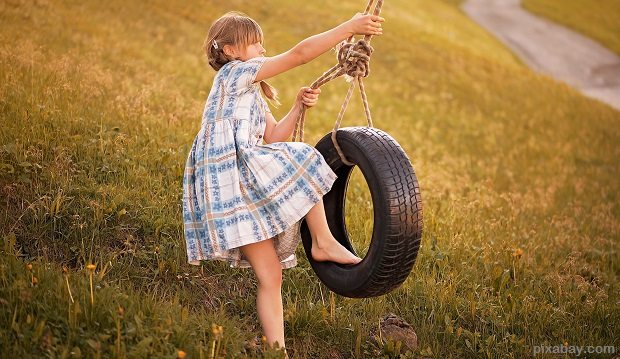 child getting on a tyre swing