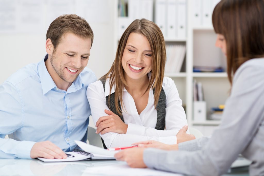 happy couple signing paperworks happy couple signing paperworks