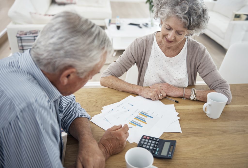 old couple talking over financial charts