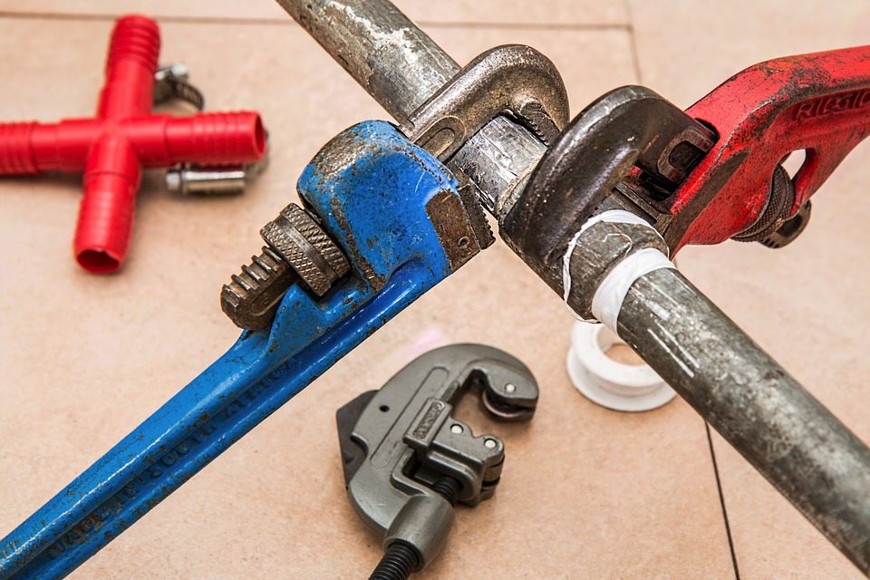 two wrenches on a pipe for plumbing two wrenches on a pipe for plumbing